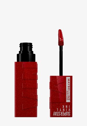Flacon rouge pailleté du Maybelline Superstay Vinyl Ink avec applicateur, montrant la teinte liquide rouge au bout.