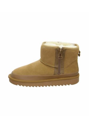 Tan suede ankle boot with a zipper on the side, lined with white fur, and a rubber sole featuring a serrated edge.