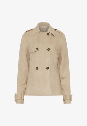 Beige dubbele-breasted jasje gemaakt van suède-achtig materiaal, met decoratieve knopen, een puntige kraag en manchetten met detail op de mouwen.