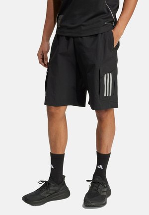 Black cargo shorts with a textured fabric, featuring two side pockets and three vertical grey stripes on the left pocket. Paired with black sneakers.