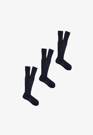 Tre paia di calzini neri fino al ginocchio disposti diagonalmente con la scritta "PEROTTI" sulla zona del piede su sfondo bianco.