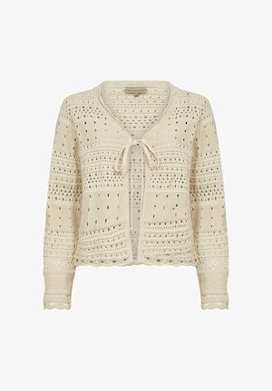 Kohev kardigan koorevärviga, punutud eesriidega, avatud töömustritega, pikkade varrukatega ja sakilise äärega. Kerge ja tekstuuriga disain.