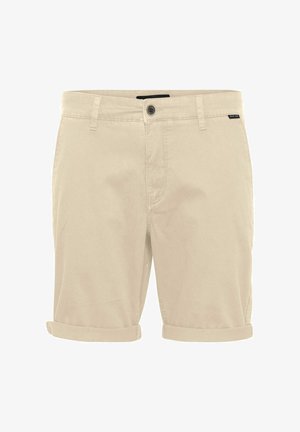 Shorts en coton beige avec un ourlet retroussé, tissu léger, fermeture à bouton et une petite étiquette de marque sur la taille.