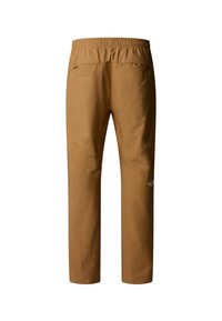 Pantalons longs marron avec une ceinture élastique, dotés de deux poches au dos et d'un petit logo sur la jambe inférieure. Tissu lisse et léger.