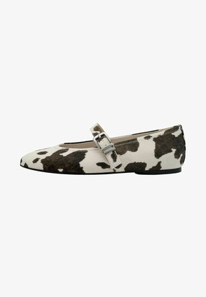 Flat shoe with a pointed toe and a black and white cow print. Features a side strap with a buckle detail and a smooth texture.