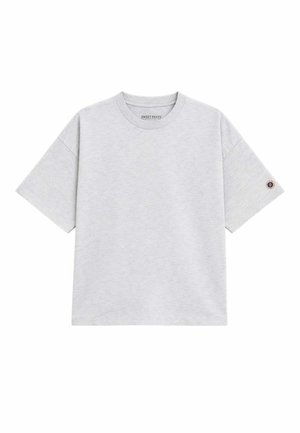T-shirt en coton gris clair à manches courtes, col rond, avec un petit logo rond sur la manche gauche.