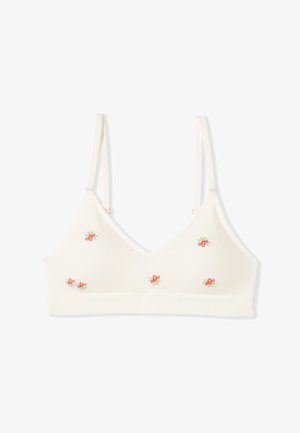 Soutien-gorge doux de couleur crème avec bretelles fines réglables et petites broderies florales orange dispersées sur les bonnets.