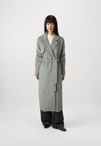 Gray wool wrap coat with a belt, lapel collar, long sleeves, double-breasted design, and hem falling below the knees. Black wide-leg pants underneath.