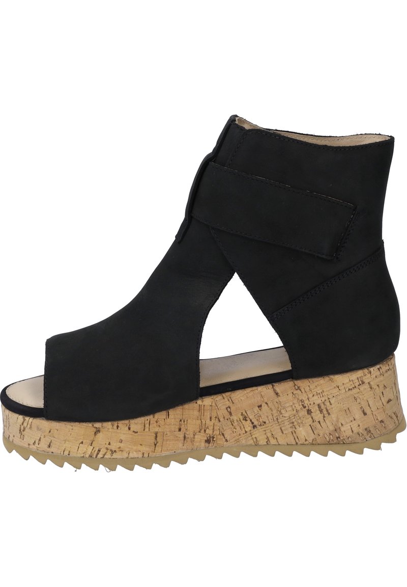 Black suede ankle boot with a cork wedge sole. Open toe design features a side cutout and a Velcro strap on the upper for secure fit.