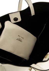 White leather tote bag with a black suede interior, featuring a zippered compartment and a removable matching pouch inside. Gold hardware accents.