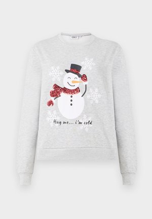 Sweatshirt gris clair avec un graphisme de bonhomme de neige portant une écharpe rouge pailletée, un chapeau noir et le texte imprimé "Fais-moi un câlin... j'ai froid." Accents de flocons de neige.