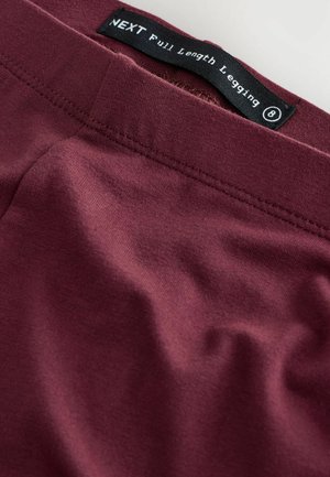 Bordowe legginsy pełnej długości wykonane z gładkiego, elastycznego materiału z płaskimi szwami. Metka mówi "NEXT Legginsy Pełnej Długości." Rozmiar 8.