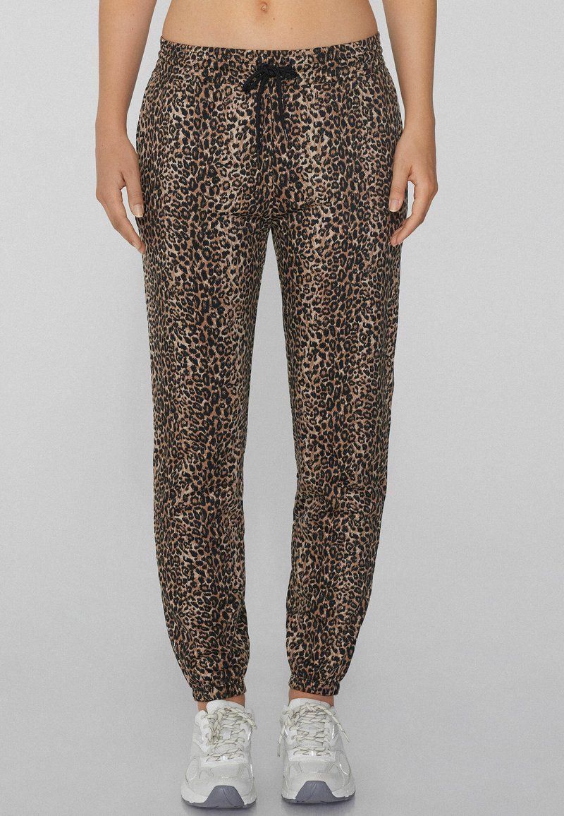 Leopardenmuster-Jogginghose mit verstellbarem Bund, schmal zulaufendem Bein und elastischen Bündchen; aus leichtem Stoff mit glatter Textur gefertigt.