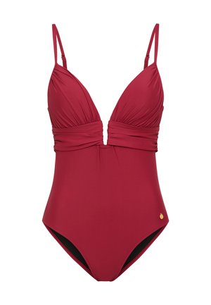 Maillot de bain une pièce en rouge profond, avec un décolleté plongeant et un tissu froncé. Bretelles ajustables et petit détail doré.