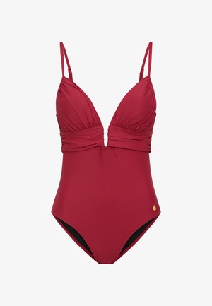 Maillot de bain une pièce en rouge profond, avec un décolleté plongeant et un tissu froncé. Bretelles ajustables et petit détail doré.