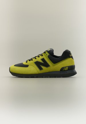 Жълтo и черно маратонка New Balance с черна подметка, връзки и лого, показана отстрани на неутрален фон.