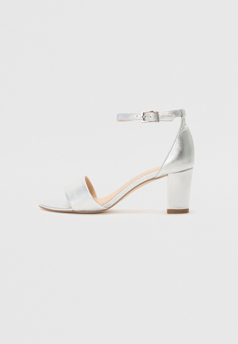 Silver metallic ankle strap sandal with a square toe, wide front band, and a block heel. Smooth texture and adjustable buckle detail.