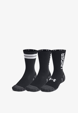 Set di calze sportive nere con design variabili: una con righe bianche, un'altra con motivi a trama e la terza con il marchio "UNDER".