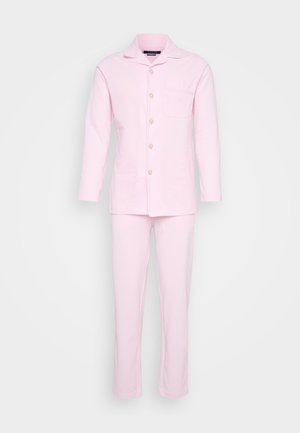 Gaiši rozā kokvilnas pidžamu komplekts ar garām piedurknēm, pogājamu krekliņu un saskaņotām biksēm ar taisnu kāju griezumu un krūšu kabatu.