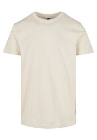 Krémové tričko s krátkým rukávem vyrobené z měkké bavlny. Má klasický kulatý výstřih a rovný střih. Minimalistický design.