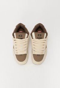 Brown and cream sneakers with a smooth leather upper, rounded toe, padded collar, and flat laces. Features logo on tongue and side.