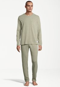Light green, long-sleeve pajama set made from soft fabric; features a chest pocket on the top and slim-fit pants.