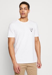 White cotton t-shirt with short sleeves, featuring a black graphic design in a triangle shape on the chest. Standard crew neck style.