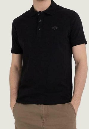 Polo negro con cuello y mangas cortas, con un pequeño logo de diamante en el pecho. Hecho de una tela suave y texturizada.