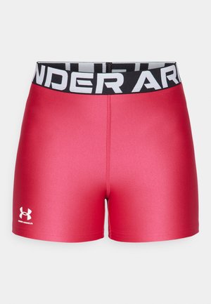 Pantalones cortos deportivos rojos con una textura suave, diseño ajustado y cinturilla ancha negra con "UNDER ARMOUR" en letras blancas.