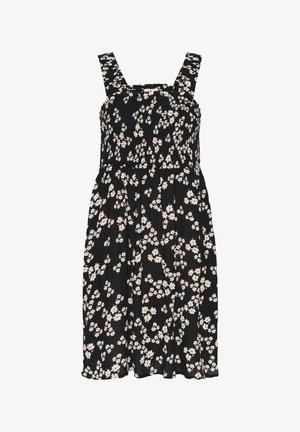 Musta kukallinen mekko, jossa on valkoisia ja punaisia kukkia, neliökaula-aukko ja leveät hihnat. Kangas on kevyesti teksturoitu ja rypytetty vyötäröltä.