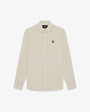 Beiges langärmeliges Hemd mit Knopfleiste, spitzem Kragen und kleinem gelbem Vogel-Logo auf der linken Brust.