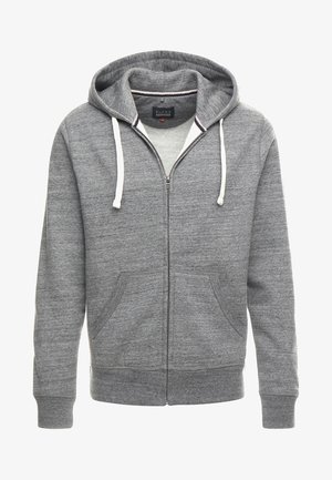 Siva zip-jakna iz mehkega bombažnega materiala. Ima kapuco s vrvico, sprednje žepke ter rebraste manšete in spodnji del.