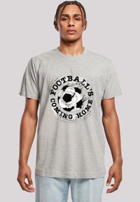 Gray cotton t-shirt featuring a circular black and white graphic with the text “FOOTBALL'S COMING HOME” and a soccer ball design.