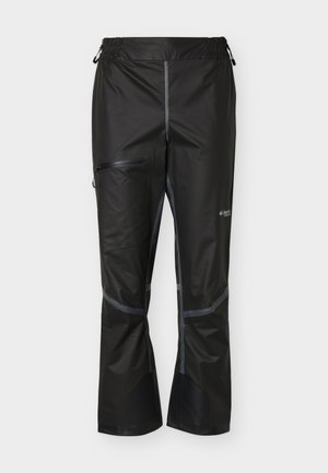 Pantalon de plein air noir imperméable avec taille élastique, poche zippée sur la cuisse et renforts aux genoux et aux chevilles.