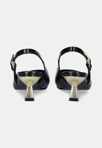 Tacones slingback de charol negro con textura de cocodrilo, acento de hebilla dorada y tacón metálico en forma de cono.