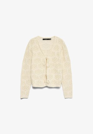 Cárdigan de punto crochet de color crema con mangas largas, escote en V y dos cierres delanteros con lazos que presentan agujeros con patrón floral.
