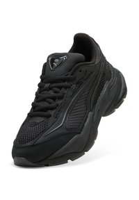 Sort Puma RS sneakers med mesh- og syntetisk overdel, tyk sål og snørebåndsdesign, vinkelret for at vise for- og yderside detaljer.