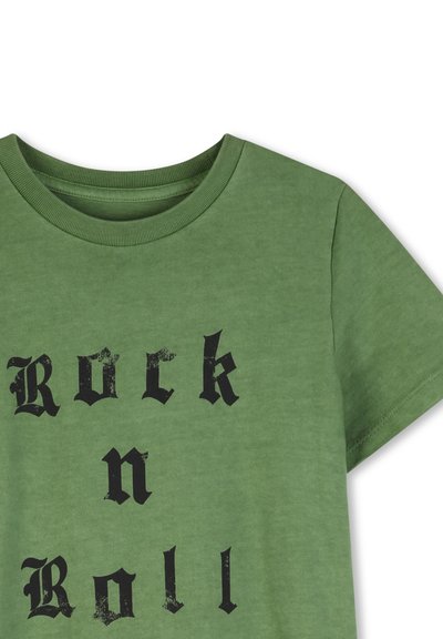 T-shirt en coton vert à manches courtes et col rond. Présente un texte "Rock n Roll" en gras noir imprimé dans une police usée.