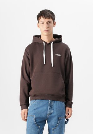 Brown hoodie with white drawstrings, front pocket, and embroidered text. Soft fabric with a relaxed fit, featuring ribbed cuffs and hem.