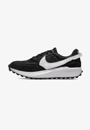 Black athletic shoe with suede and mesh materials. Features a white Nike swoosh logo, textured sole, and a prominent padded collar.