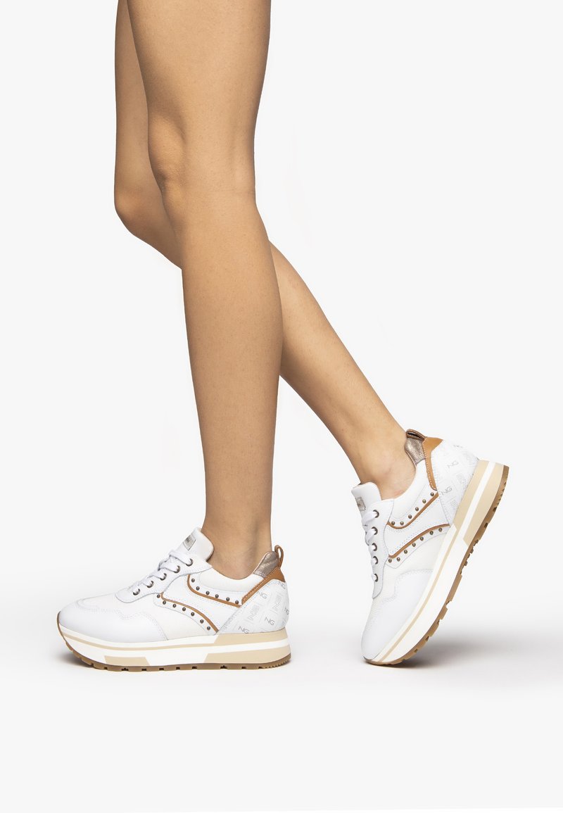 Weiße Sneakers mit einem strukturierten Lederoberteil, bronzefarbenen Akzenten, schnürbarem Design und dekorativen Nieten an der Seite. Gummisohle mit Grip.