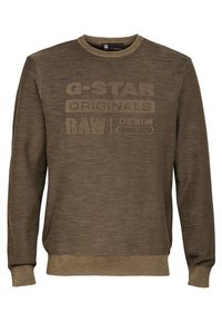 Brun långärmad crewneck sweatshirt med ribbade ärmslut och nederkant, med präglad text "G-STAR ORIGINALS RAW DENIM" på framsidan.