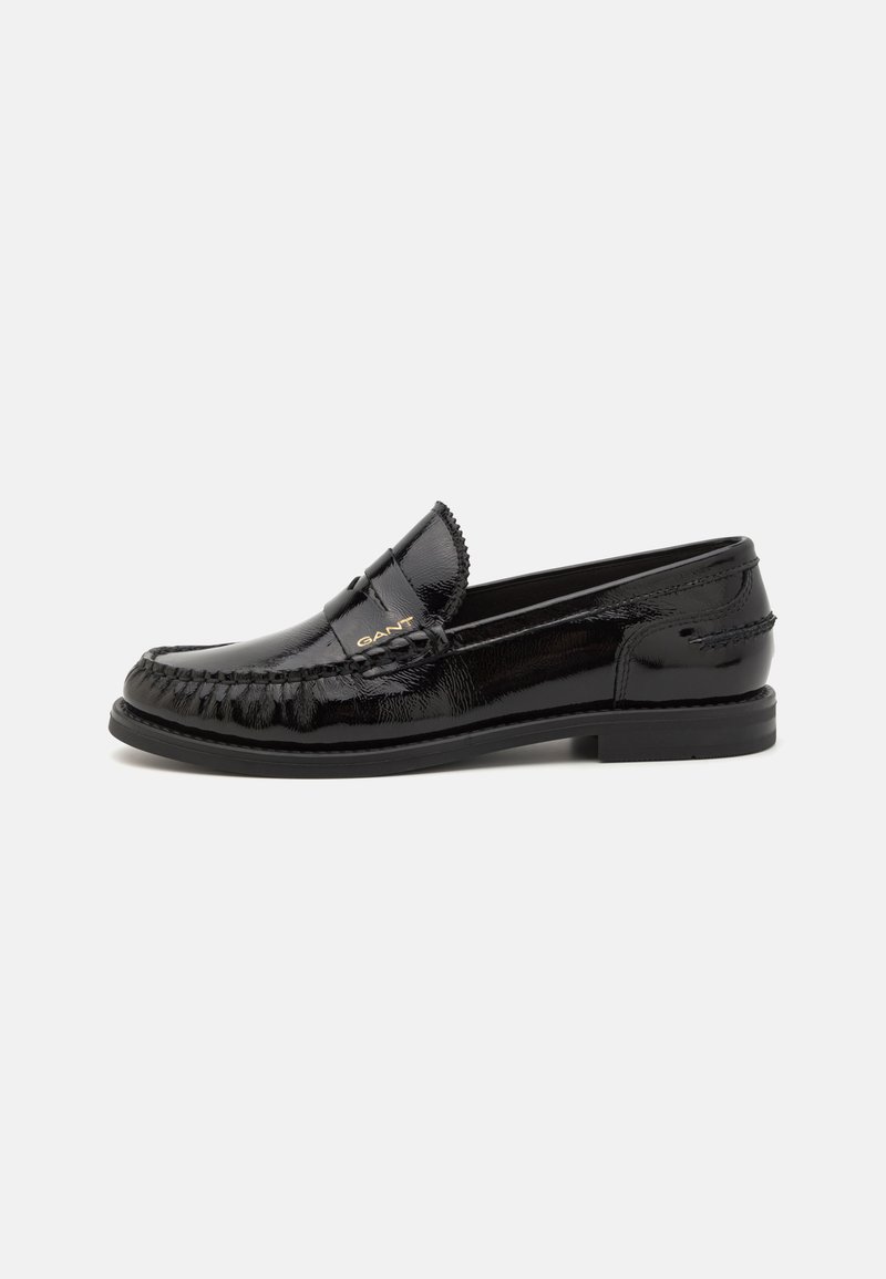 Black leather loafers with a patent finish, textured stitching, and a small emblem on the strap. Low heel and smooth soles.