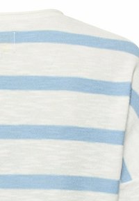 Hvidt stof med vandrette lyseblå striber, der viser en tæt på blød strikket tekstur og en del af et tøjs skulder og ærme.