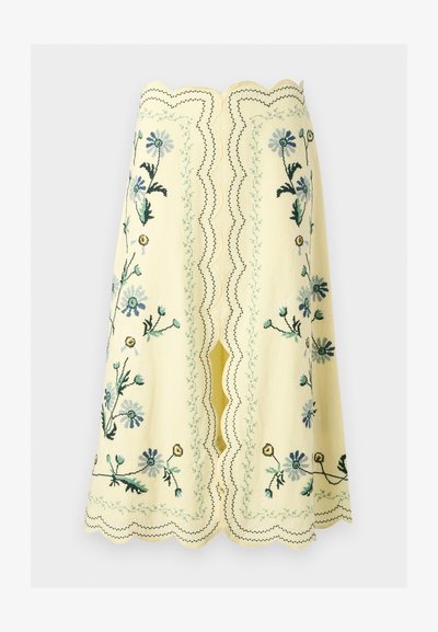 Κίτρινη φούστα μέχρι το γόνατο με κυματιστές άκρες και κεντήματα με λουλούδια σε μπλε, πράσινο και κίτρινο, με κεντρική σχισμή και διακοσμητικές ραφές.