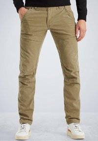 Khaki cotton pants with a slim fit, featuring angled front pockets and knee panels. Paired with white sneakers. Smooth texture, casual design.