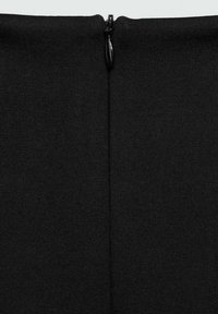 Čierna tkanina s hladkým povrchom a zipsom na vrchu, ktorá predvádza elegantný a minimalistický dizajn.