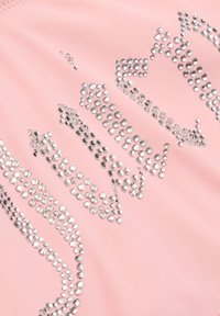 Tissu rose ornés de strass en argent disposés dans un motif fluide. La texture est lisse avec un léger éclat.