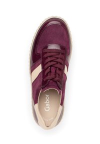 Burgundy suede sneaker with glossy accents, round toe, cushioned insole, and flat laces. Features a beige stripe on the side.
