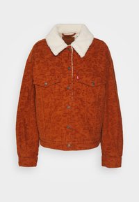 Hnědo-oranžová kordurová bunda s bílým kožešinovým límcem, předními patentkami a dvěma náprsními kapsami. Texturovaná látka s vertikálními žebry.